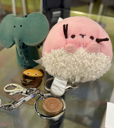A green elephant and a pink squishy key chain