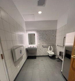 Public bathroom with gray floor and white walls
