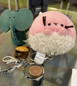 A green elephant and a pink squishy key chain