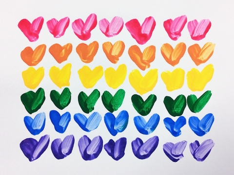 A picture of rows of painted rainbow hearts.