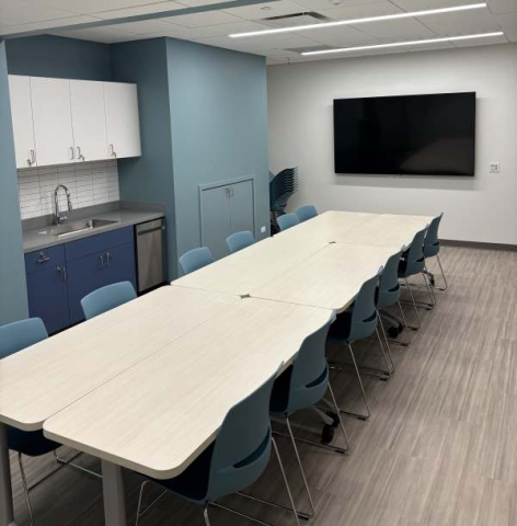 Meeting room space with tables and tv