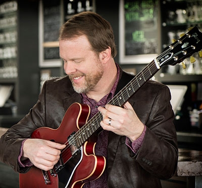 Neal Alger musician playing his guitar