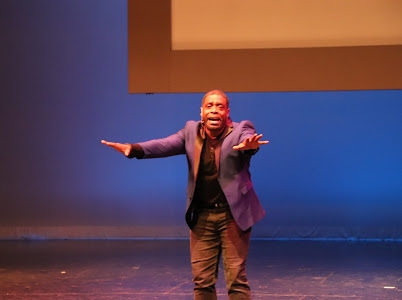 Black actor with arms extended