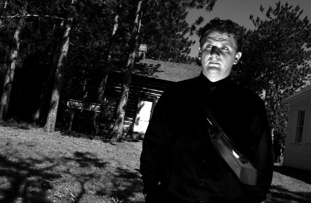 Chad Lewis standing in the shadows