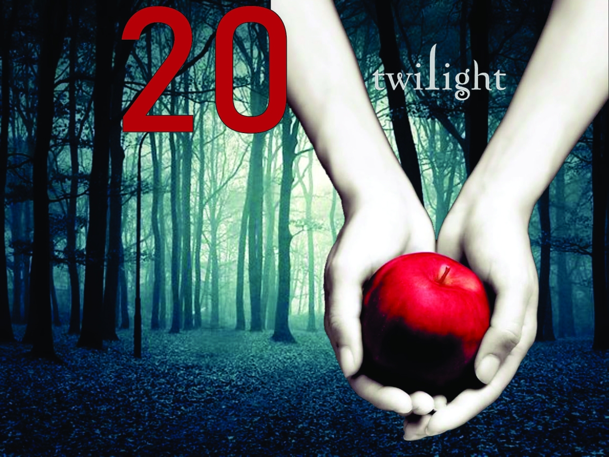 Mysterious woods and hands holding a red apple in foreground