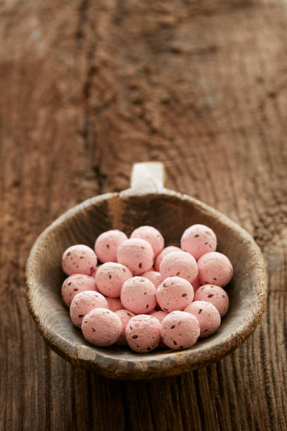 A photo of a bowl of pink balls.