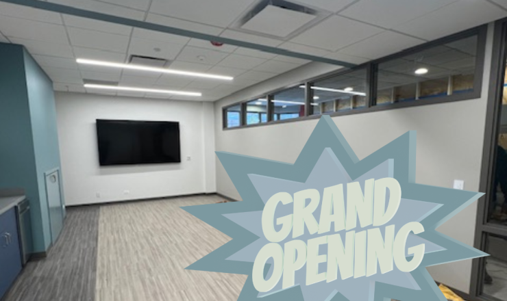 Photo of meeting room with word grand opening in the front